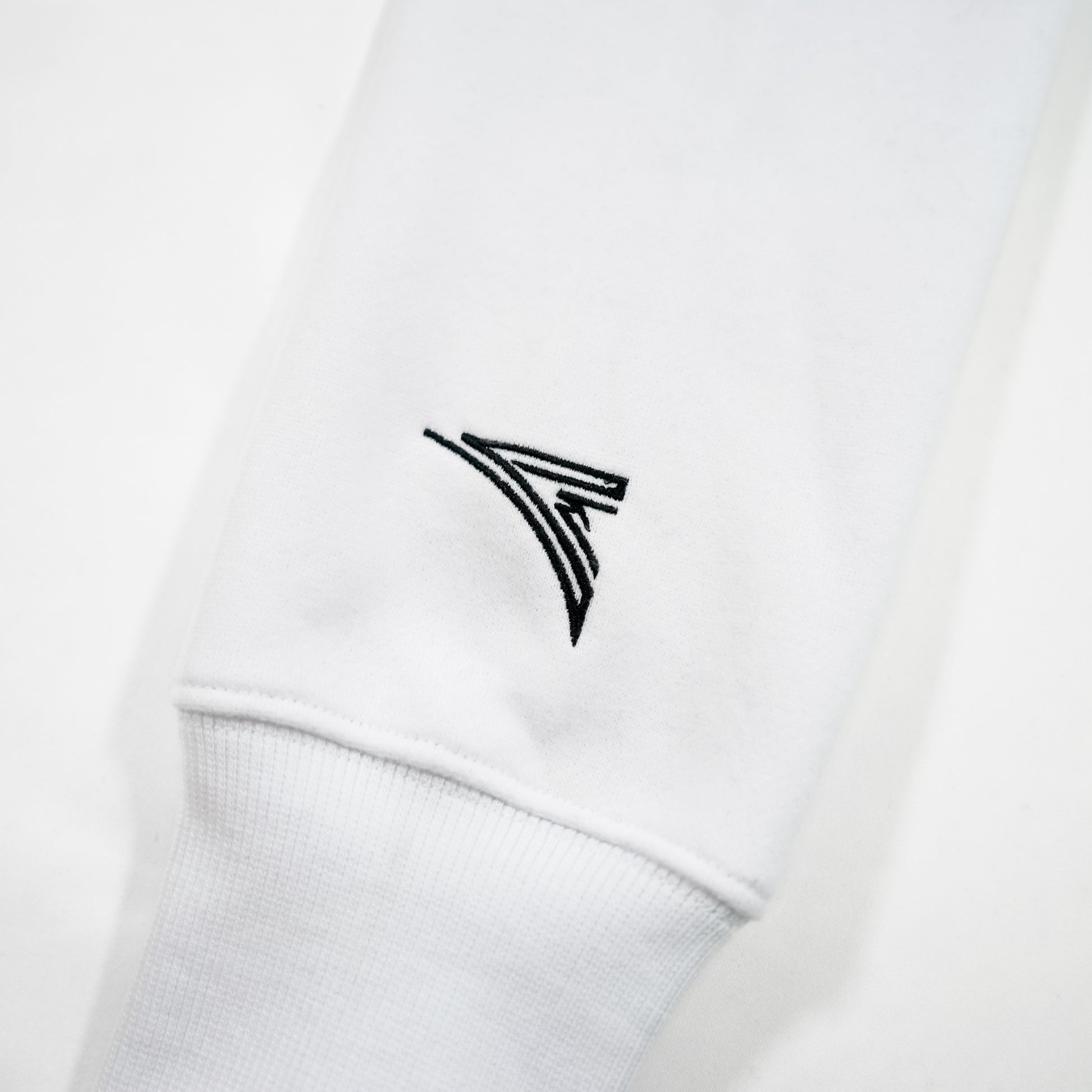 white sleeve with black embroidered logo