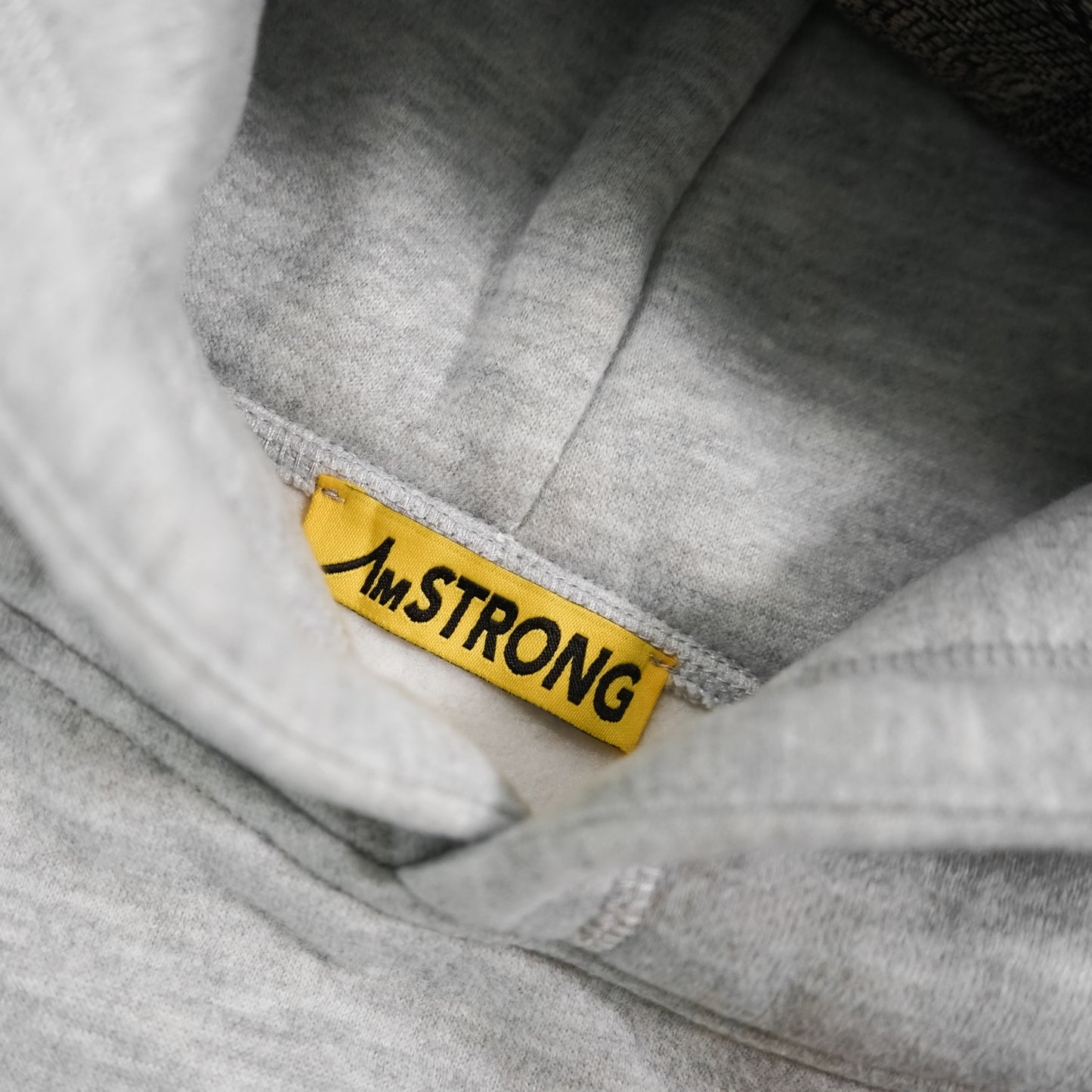 grey hoodie with AmSTRONG yellow tag 