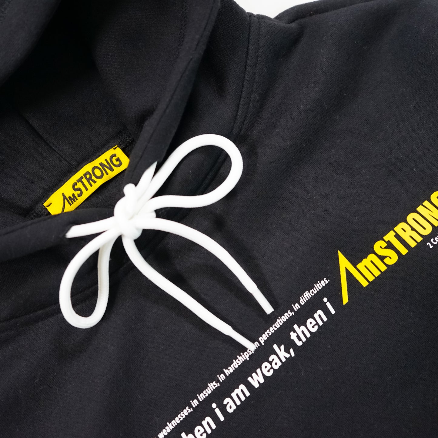 black hoodie with a AmSTRONG yellow tag