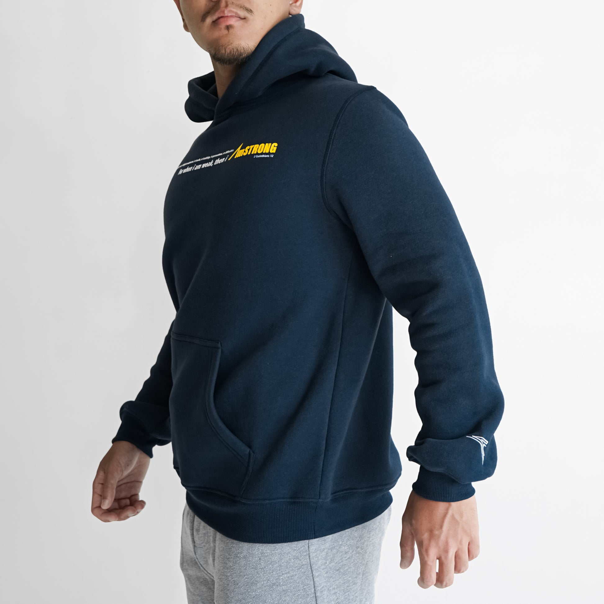 man in a navy blue hoodie which has a statement print in the front