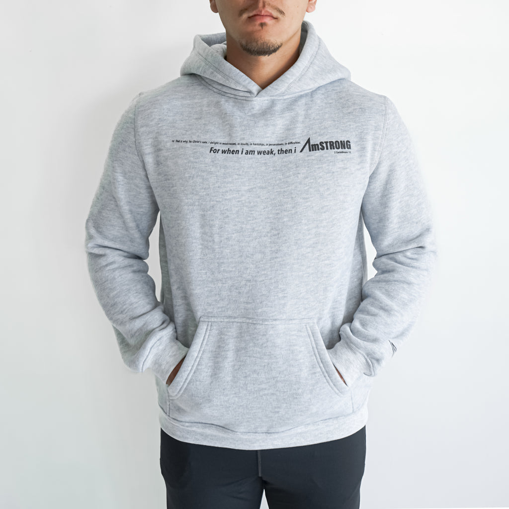 man wearing a grey hoodie with his hands in kangaroo pocket 