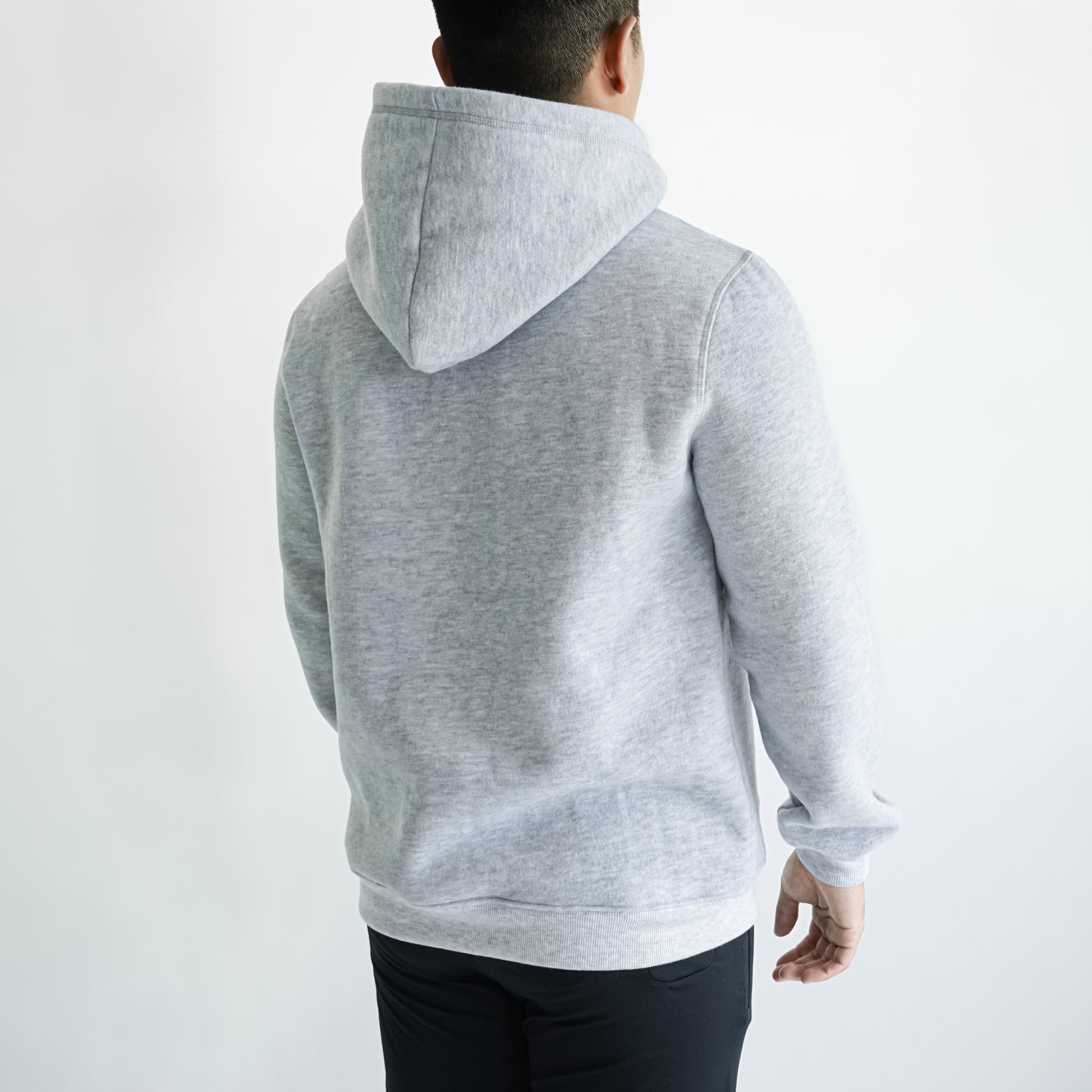 back of a man in grey hoodie