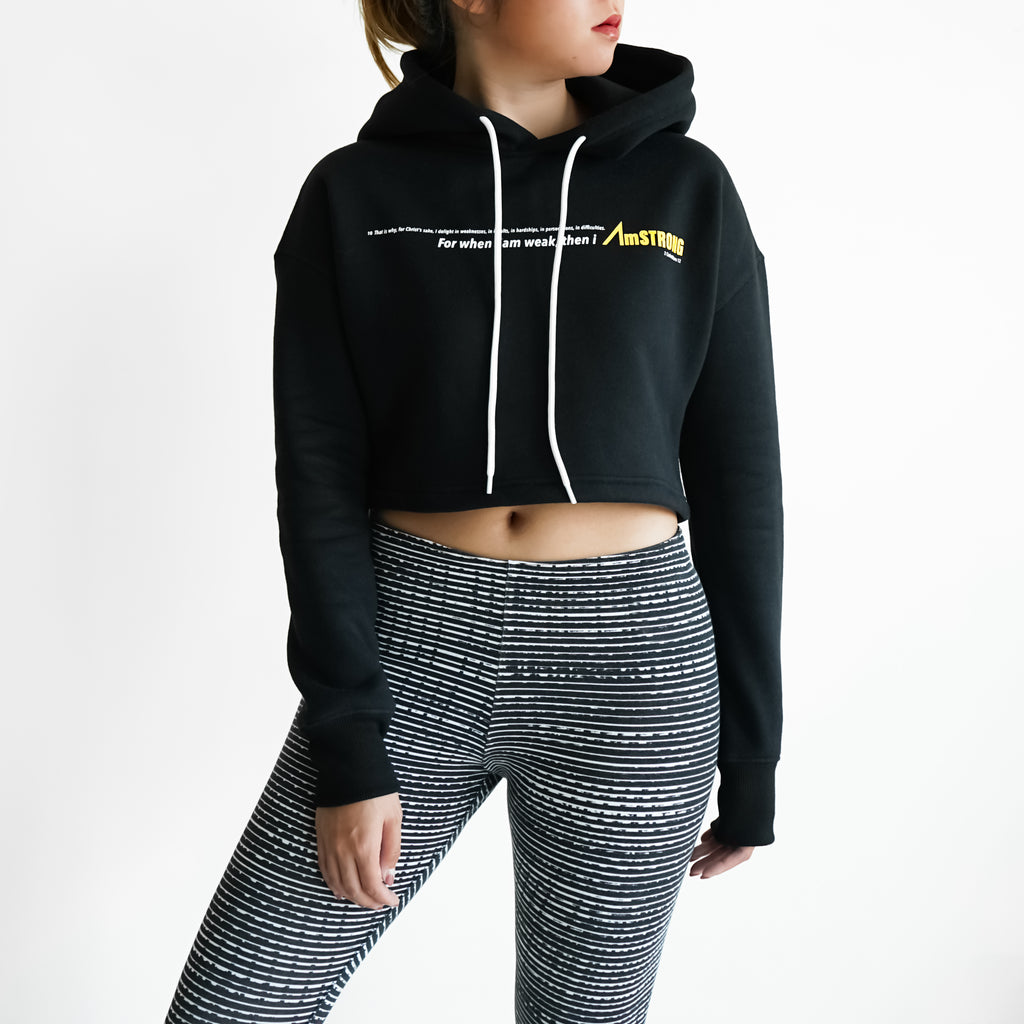woman in a black cropped hoodie and leggings