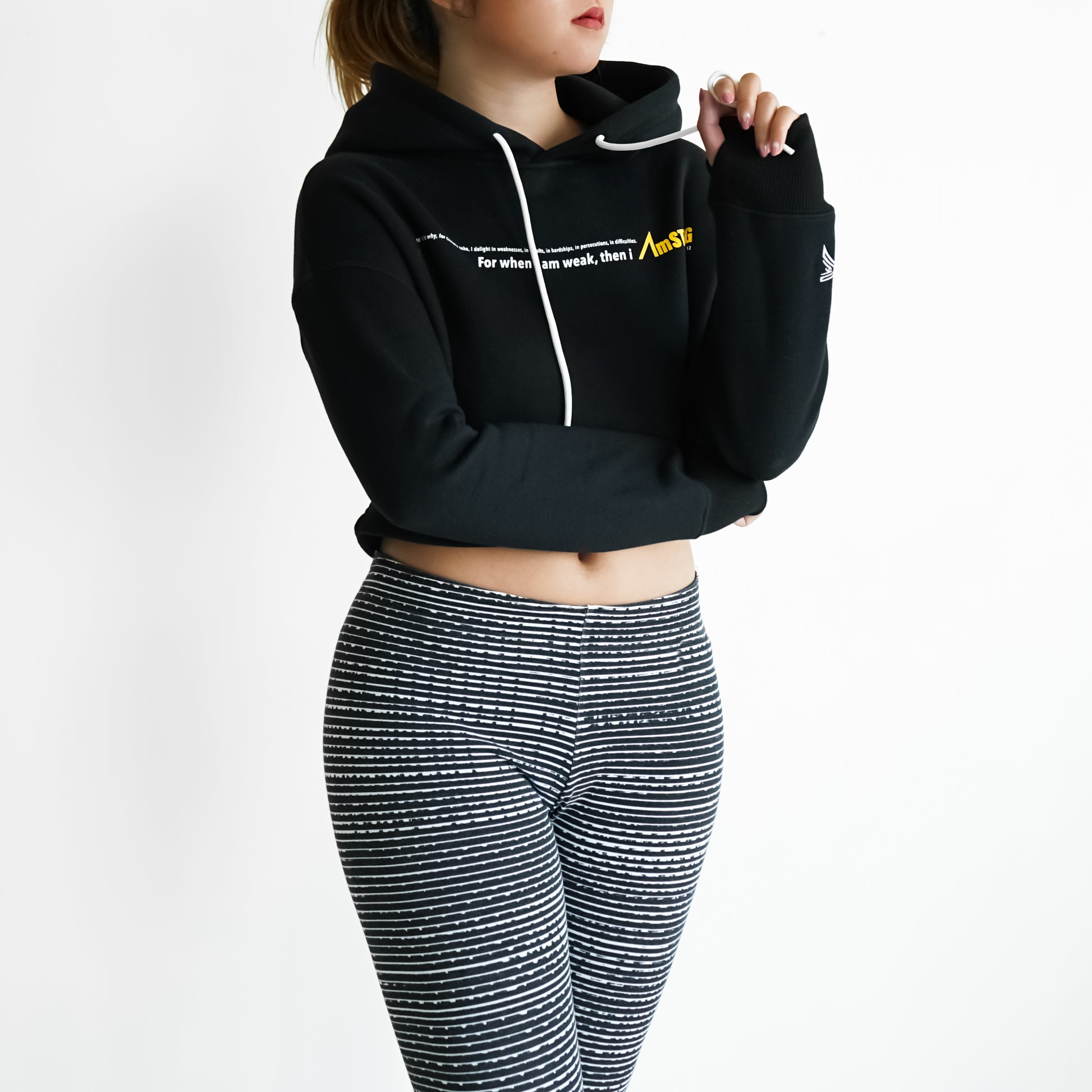 woman in a black cropped hoodie and leggings