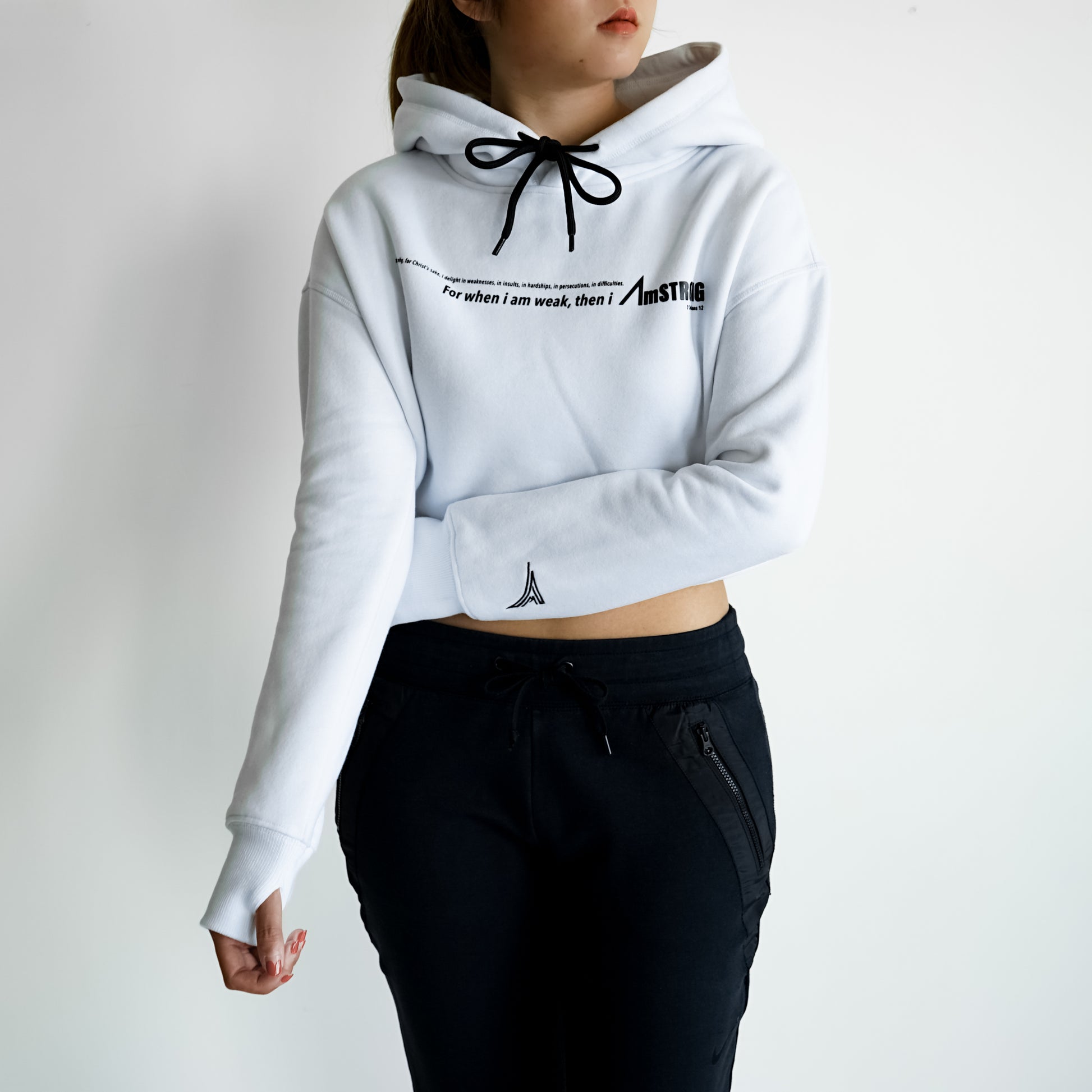 woman in white cropped hoodie and black pants