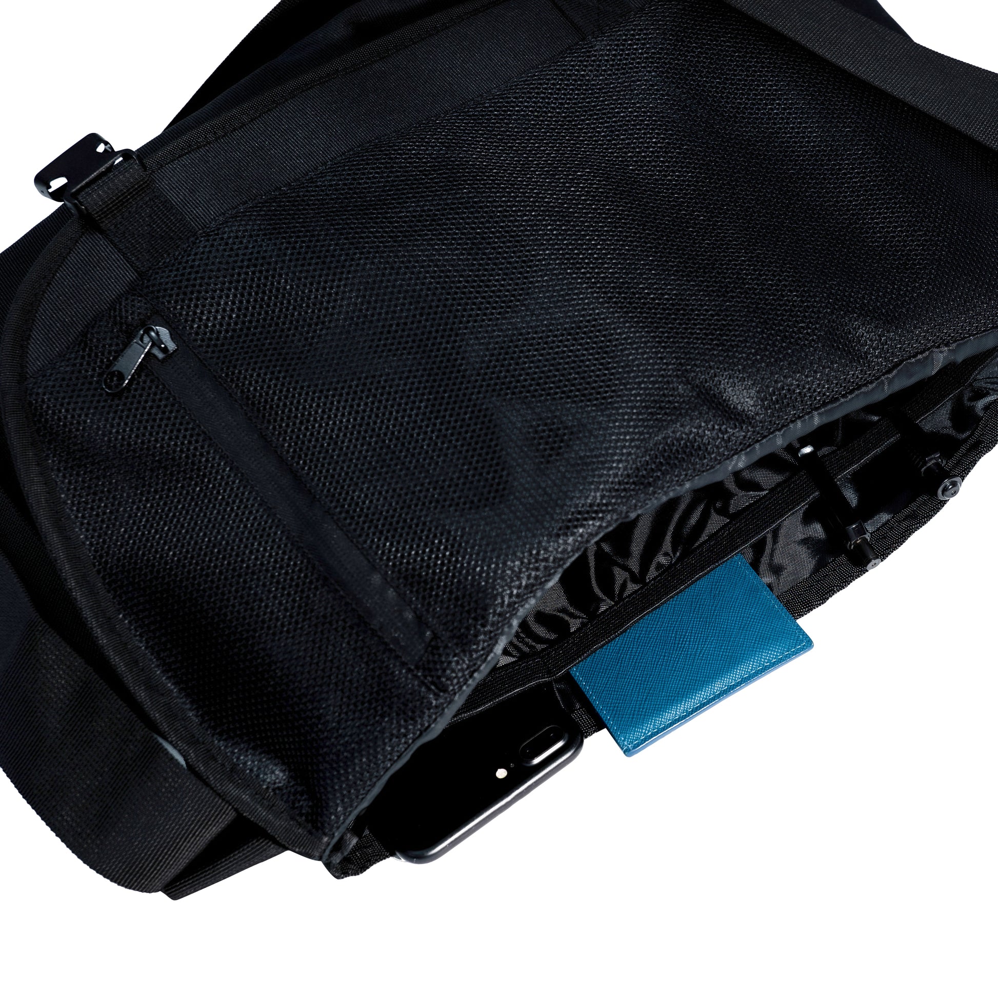 multiple pockets inside a black messenger bag
